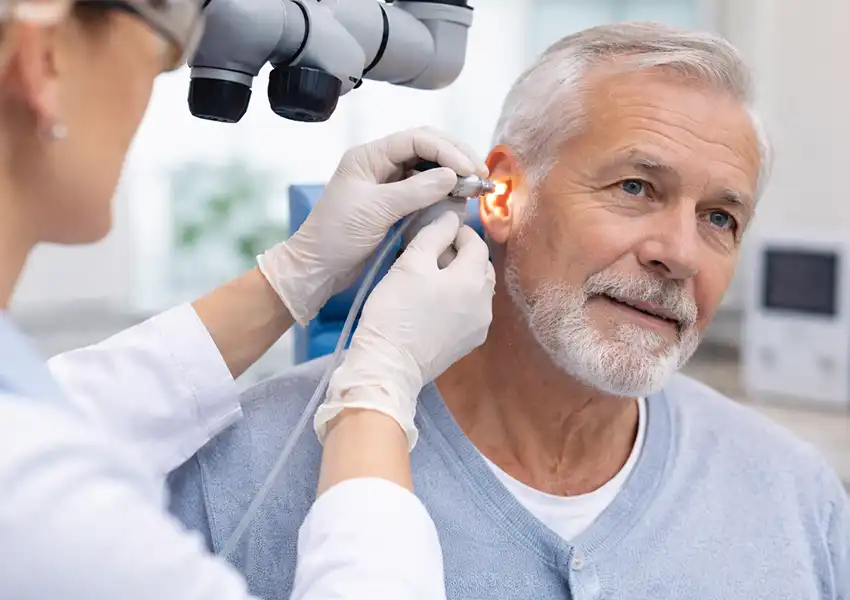 Earwax removal appointments in Northern Ireland with a patient receiving microsuction treatment in a clinic